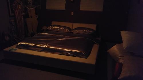 Kingsize bed in the spare bedroom with silver acetate satin sheets