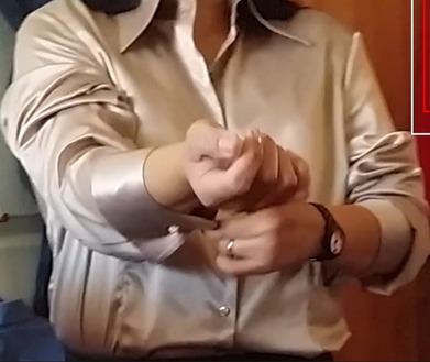 Adusting her satin cuffs... fetish heaven for me... i love worshipping satin blouses!!